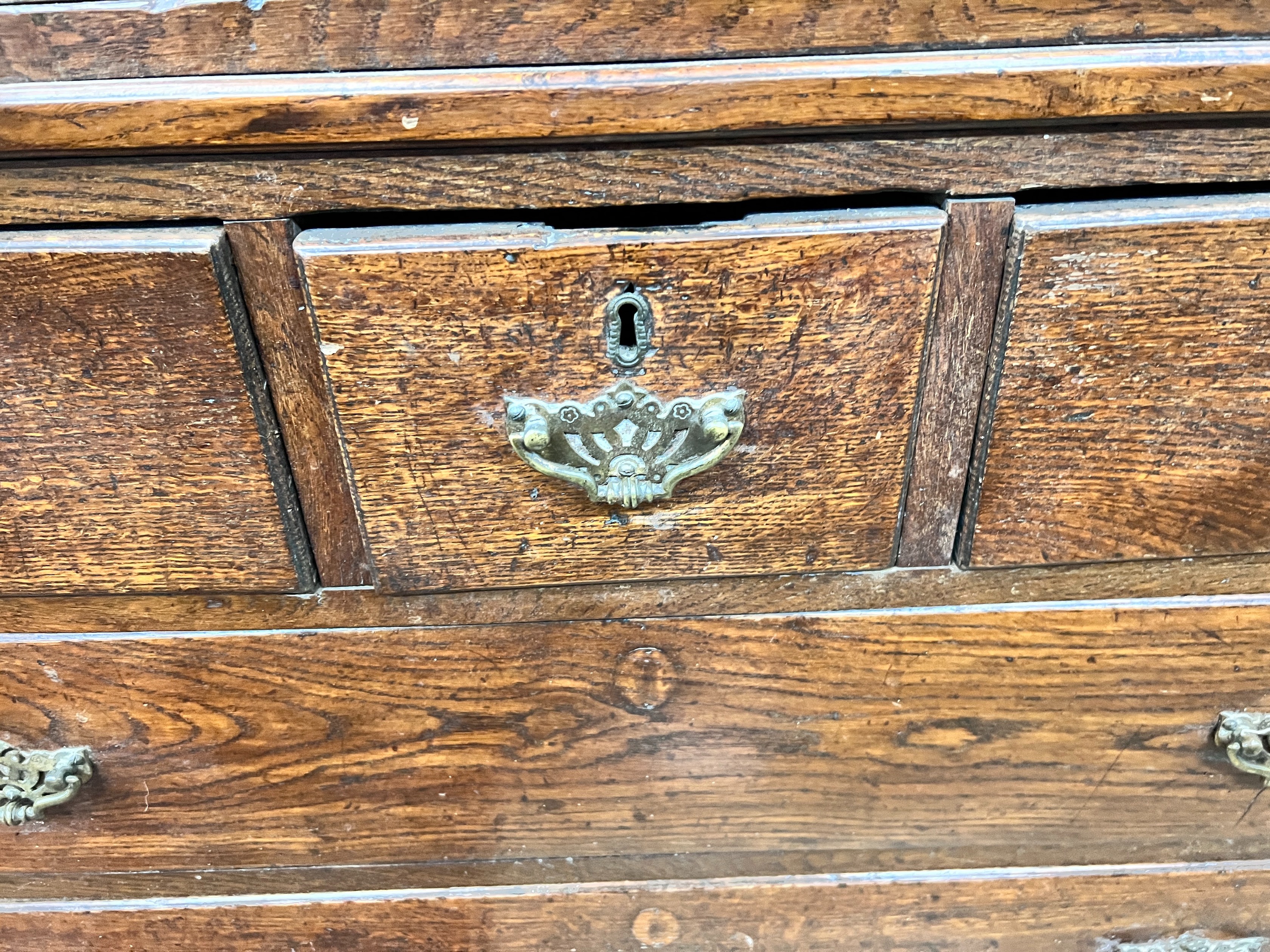 A George III oak press cupboard with two panelled doors over five drawers, width 111cm, depth 53cm, height 186cm *Please note the sale commences at 9am.